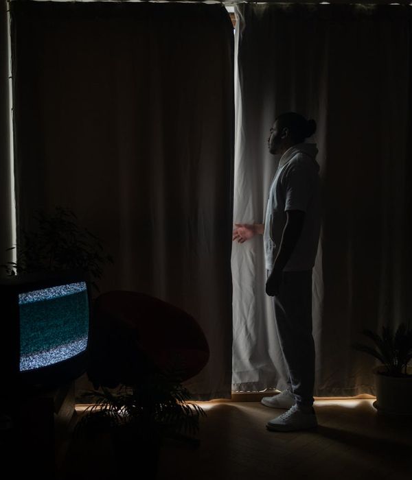 Woman in activewear moving gracefully in a softly lit room.